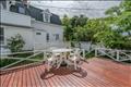 Newly stained mahogany  deck overlooking backyard