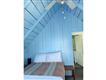 Beautiful blue bedroom with serene coastal decor and natural light.