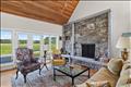 The living room features a Lew French stone fireplace.