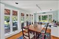 The dining room opens onto the sunroom/porch.