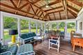 The sunroom/porch offers additional space for entertaining and enjoyment.